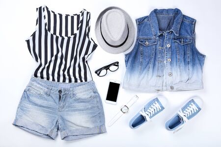 Modern women's clothes with accessories and smartphone on white backgroundの写真素材