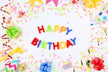 Text Happy Birthday by plastic letters with decorations and confetti on white backgroundの写真素材