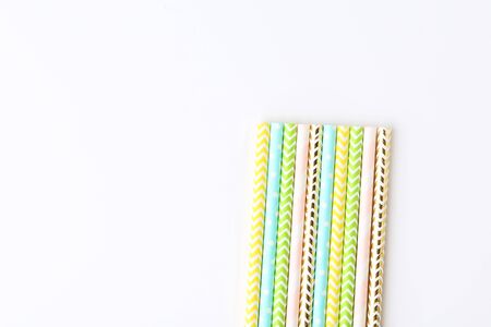 Colorful paper straws on white background