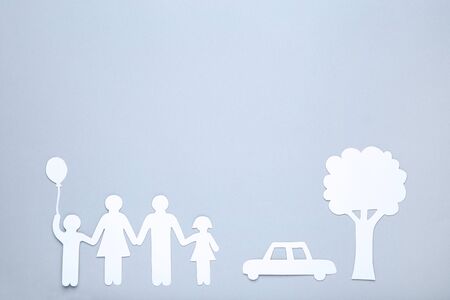Paper family figures with tree and car on grey backgroundの写真素材