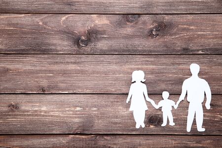 Family figures on brown wooden tableの写真素材