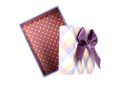 Open gift box with purple bow isolated on white backgroundの写真素材