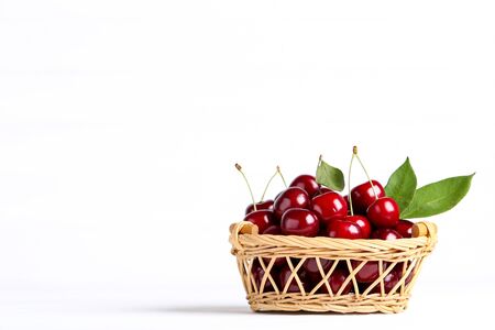 Sweet cherries in basket on white backgroundの写真素材