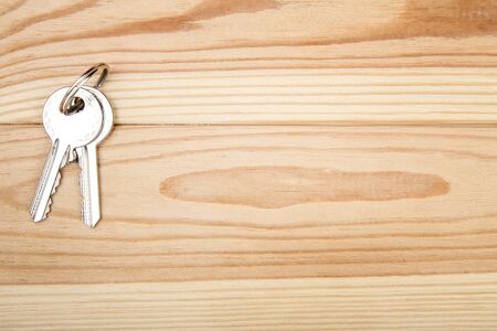 House keys on brown wooden tableの写真素材