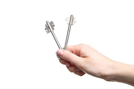 Female hand holding house keys on white backgroundの写真素材