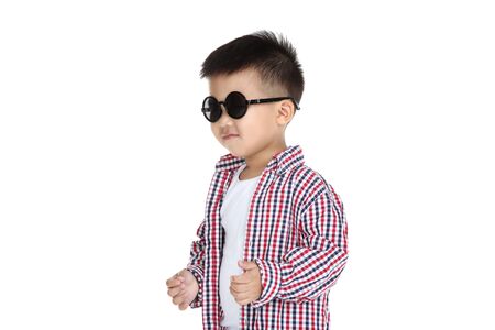 Beautiful boy in fashion clothing and sunglasses on white backgroundの写真素材