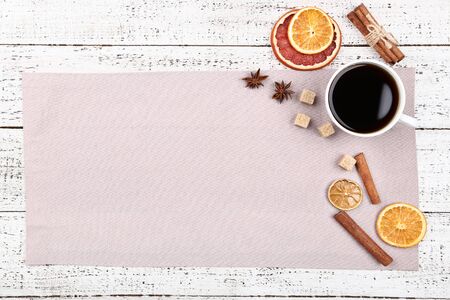 Dried citrus fruits with spices and cup of coffee on white wooden tableの写真素材