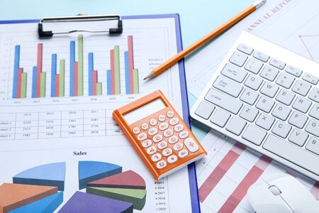 Financial papers with keyboard, calculator and pencil
