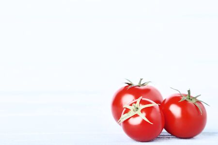 Fresh and ripe tomatoes on wooden tableの写真素材