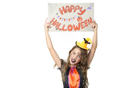 Beautiful girl in costume holding paper with text Happy Halloween on white backgroundの写真素材