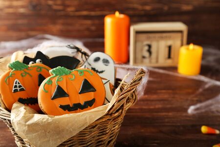 Halloween gingerbread cookies in basket on brown wooden tableの写真素材