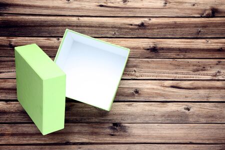 Open green gift box on brown wooden tableの写真素材