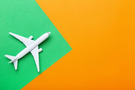 Airplane model on colorful paper background