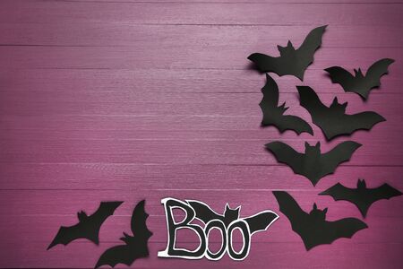 Paper halloween bats on purple wooden tableの写真素材