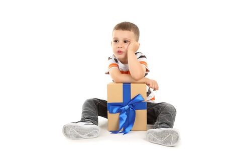 Cute little boy with gift box isolated on whiteの写真素材