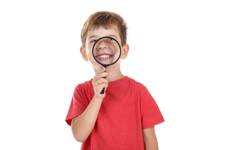 Little boy with magnifying glass on white backgroundの写真素材