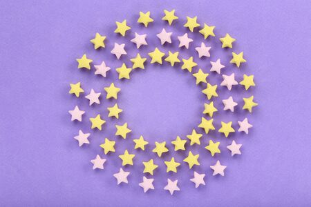 Colorful paper stars on purple backgroundの写真素材