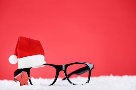 Santa hat with eyeglasses and star on red backgroundの写真素材