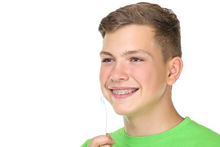 Young man with toothbrush isolated on white backgroundの写真素材