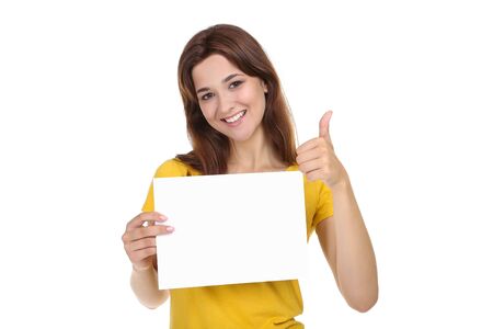 Young woman with blank sheet of paper and thumb up on white background