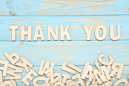 Word Thank You by wooden letters on blue tableの写真素材