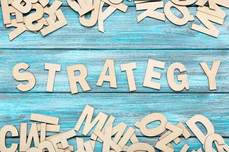 Word Strategy by wooden letters on blue tableの写真素材