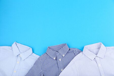 Baby clothes on blue backgroundの写真素材