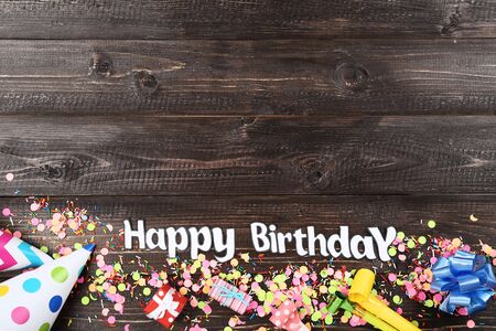 Text Happy Birthday with party decorations on wooden tableの写真素材