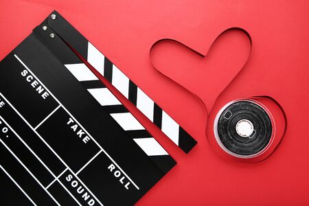 Clapper board with tape on red backgroundの写真素材