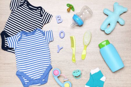 Clothes with baby supplies on the floorの写真素材