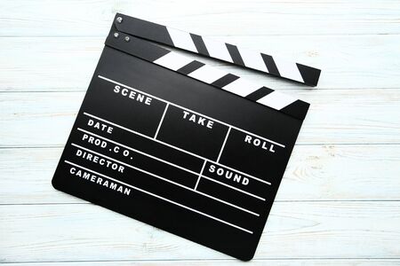 Clapper board on wooden tableの写真素材