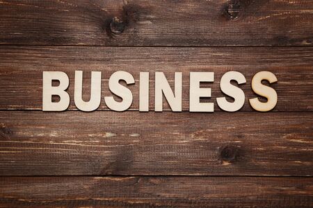 Word Business by wooden letters on brown tableの写真素材