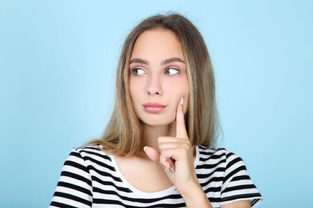 Beautiful young woman on blue background