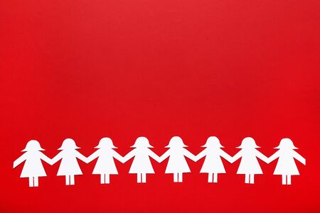 Paper chain people on red backgroundの写真素材