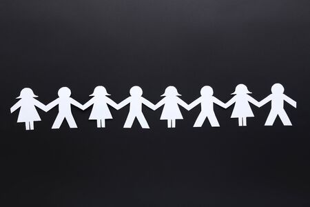 Paper chain people on black backgroundの写真素材