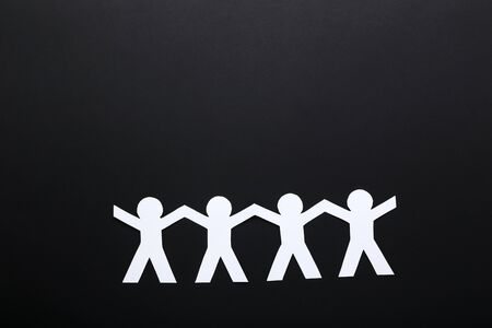 Paper chain people on black backgroundの写真素材