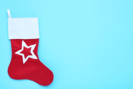 Red christmas stocking on blue background