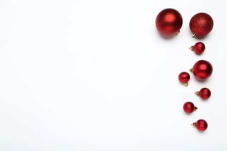 Flat lay christmas composition. Red baubles on white backgroundの写真素材