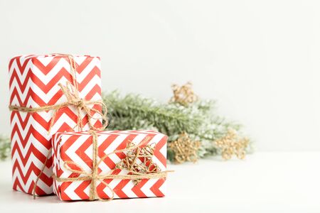 Gift boxes with ornaments and fir tree branches on white backgroundの写真素材