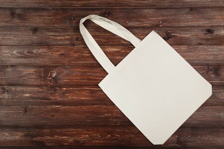 White cotton eco bag on brown wooden tableの写真素材