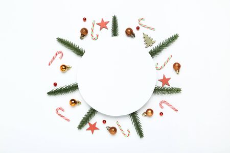 Flat lay christmas composition. Ornaments, fir tree branches and candiesの写真素材