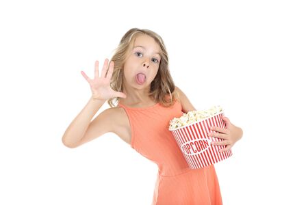 Young girl holding bucket with popcorn on white backgroundの写真素材