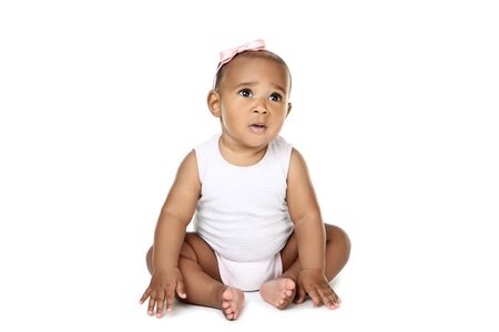 American baby girl sitting on white backgroundの写真素材