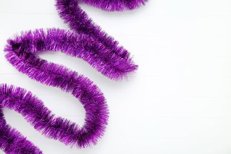 Christmas tinsel on white wooden tableの写真素材