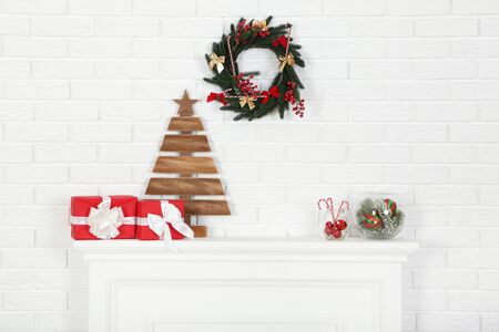 Decorated fireplace for christmas near brick wall at homeの写真素材