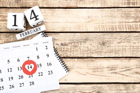 Valentine day calendar with wooden cubes on brown table