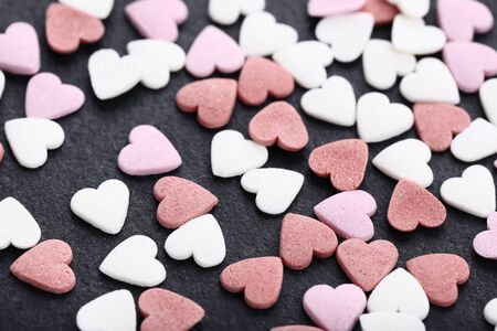 Heart shaped sprinkles on black background