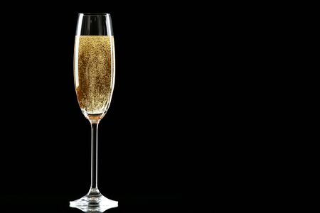 Glass with champagne on black backgroundの写真素材