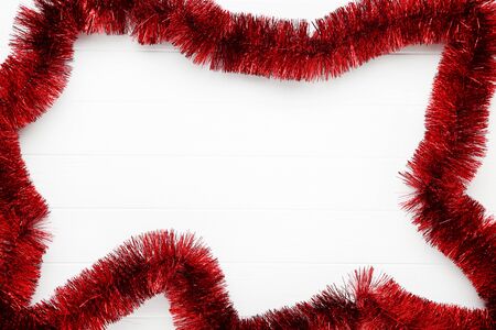 Christmas tinsel on white wooden tableの写真素材