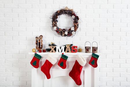 Decorated fireplace for christmas near brick wall at homeの写真素材